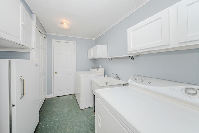 laundry area featuring a sink, independent washer and dryer, cabinet space, dark floors, and ornamental molding