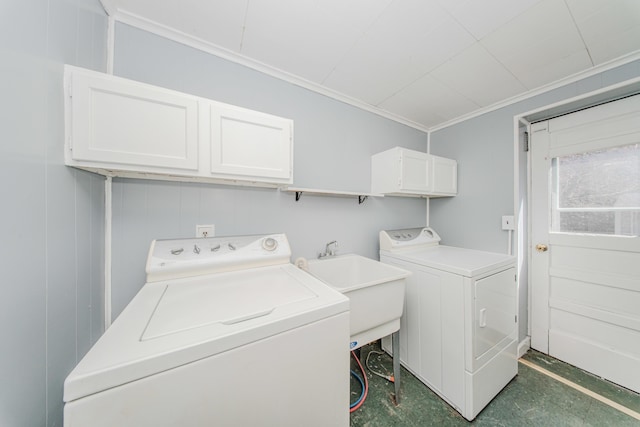 laundry area with washer and dryer, cabinet space, and crown molding