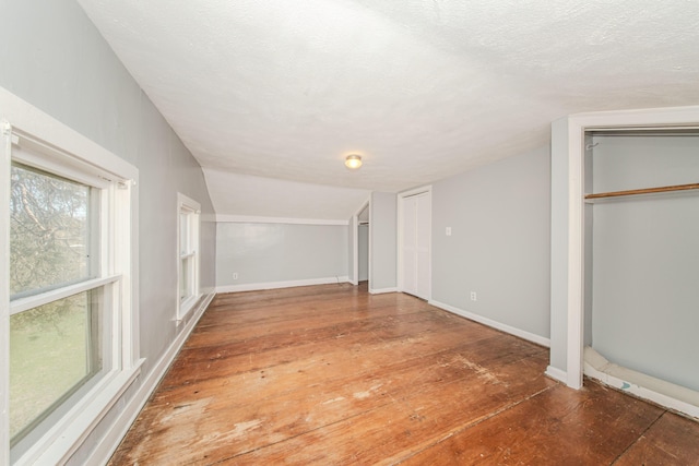 below grade area featuring hardwood / wood-style flooring and baseboards