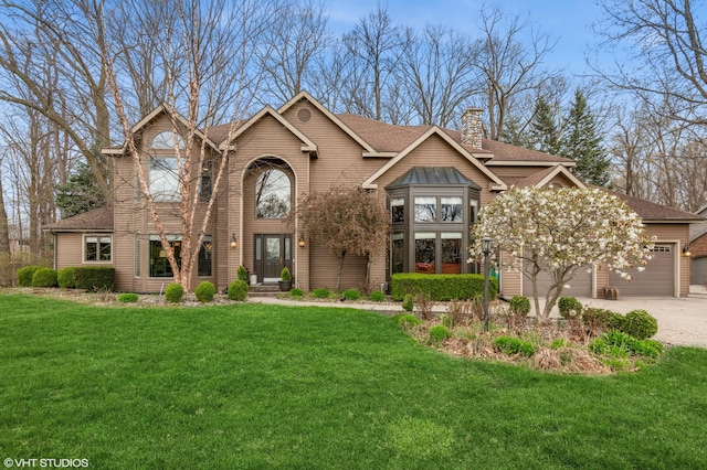 1888 Boardwalk, Saint Joseph, MI 49085 - traditional-style house with a chimney, a shingled roof, concrete driveway, an attached garage, and a front yard
