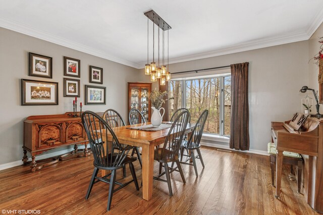 1888 Boardwalk, Saint Joseph, MI 49085 - dining area featuring baseboards, crown molding, wood finished floors, and a chandelier