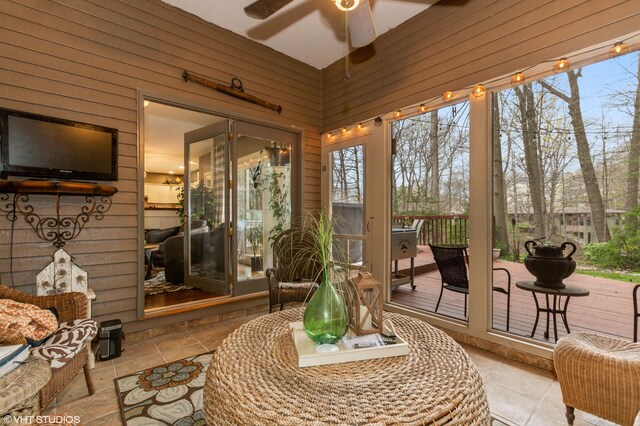 1888 Boardwalk, Saint Joseph, MI 49085 - sunroom with wooden walls, stone tile floors, and ceiling fan