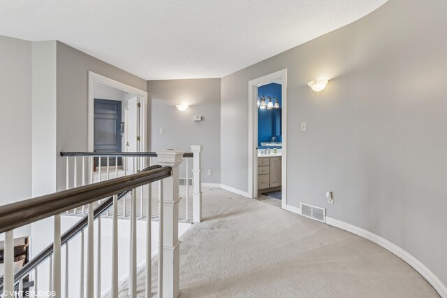 1888 Boardwalk, Saint Joseph, MI 49085 - hall with light carpet, an upstairs landing, visible vents, and baseboards