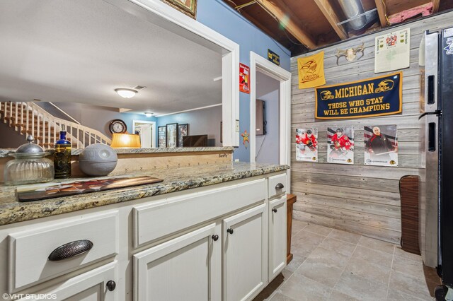 1888 Boardwalk, Saint Joseph, MI 49085 - kitchen with light stone countertops and white cabinetry