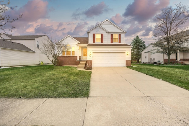 traditional home featuring brick siding, an attached garage, a front yard, and concrete driveway