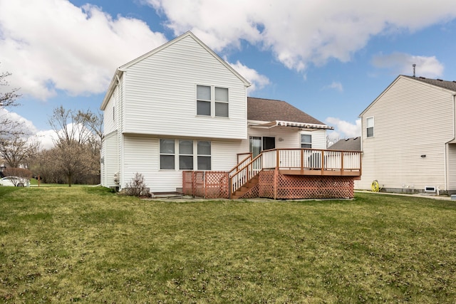 rear view of property with a yard and a deck
