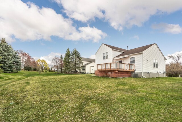 rear view of property with a yard, central AC, and a deck