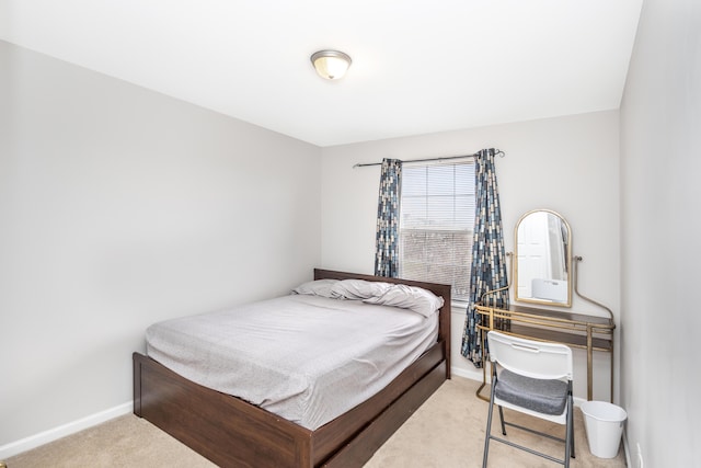 carpeted bedroom featuring baseboards