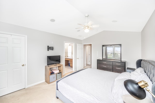 bedroom with vaulted ceiling, baseboards, light colored carpet, a ceiling fan, and connected bathroom