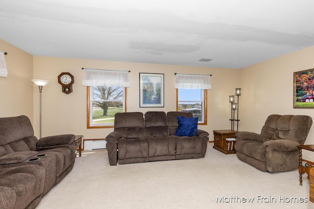 living room with a baseboard radiator, carpet, and baseboards
