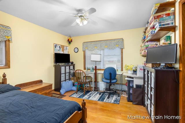 bedroom with a ceiling fan and wood finished floors