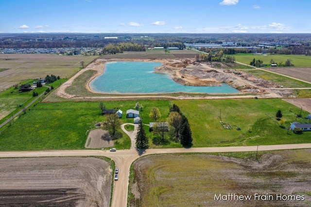 birds eye view of property with a rural view and a water view
