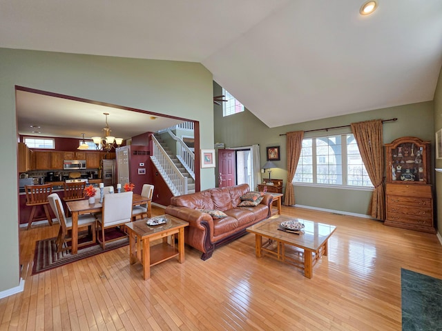 5795 Versailles Ave, Ann Arbor, MI 48103 - living room with a chandelier, light wood-style floors, a healthy amount of sunlight, and stairs