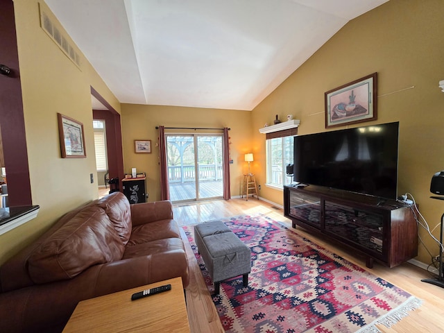 5795 Versailles Ave, Ann Arbor, MI 48103 - living area featuring lofted ceiling, visible vents, light wood finished floors, and baseboards