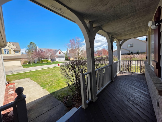 5795 Versailles Ave, Ann Arbor, MI 48103 - wooden deck featuring covered porch, a yard, and a residential view
