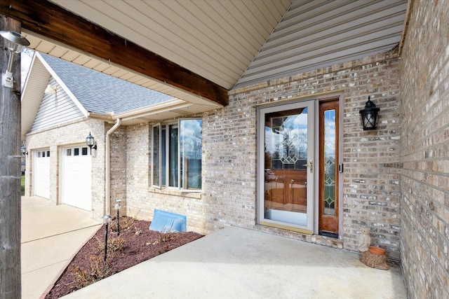 6030 Paw Paw Lake Rd, Coloma, MI 49038 - property entrance with concrete driveway, brick siding, and roof with shingles