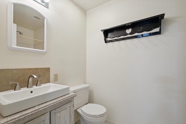 6030 Paw Paw Lake Rd, Coloma, MI 49038 - bathroom featuring toilet, vanity, and visible vents