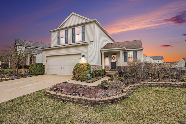 traditional home with concrete driveway, stone siding, an attached garage, fence, and a yard