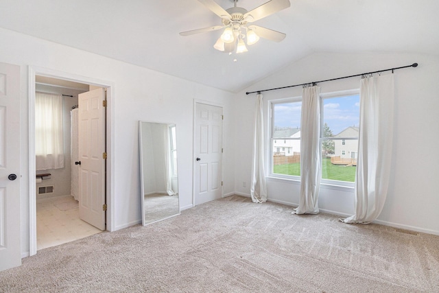 unfurnished bedroom featuring vaulted ceiling, carpet, visible vents, and baseboards