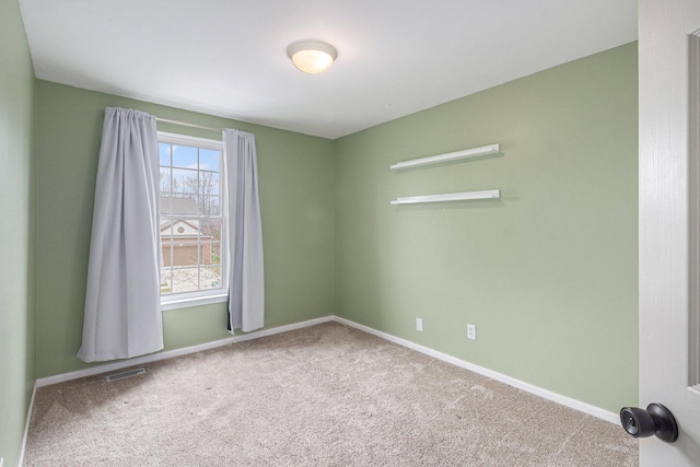 carpeted empty room with baseboards and visible vents