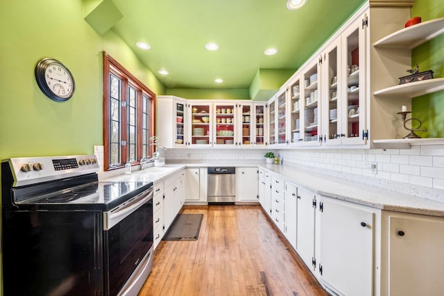 kitchen with electric range oven, dishwasher, tasteful backsplash, and white cabinetry