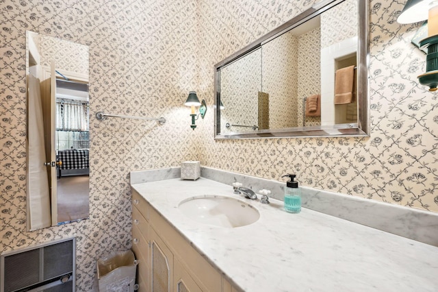 bathroom featuring wallpapered walls, visible vents, and vanity