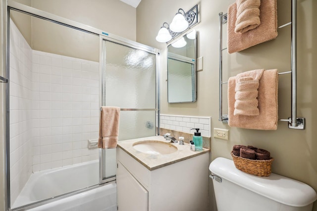 full bath featuring combined bath / shower with glass door, vanity, and toilet
