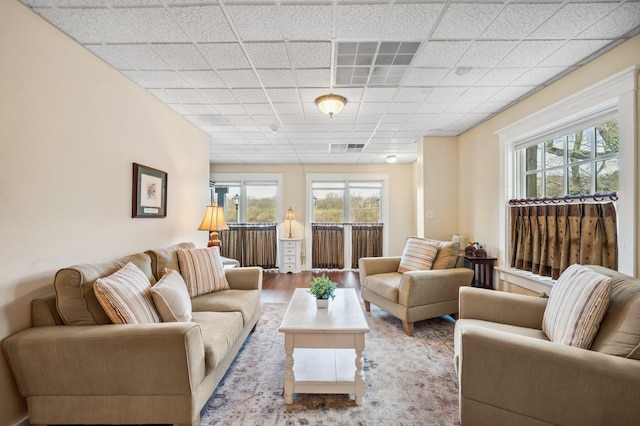 living area featuring wood finished floors, visible vents, and a wealth of natural light