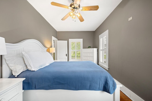 bedroom with baseboards, a ceiling fan, and wood finished floors