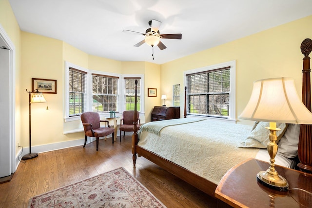 bedroom featuring baseboards, a ceiling fan, and wood finished floors