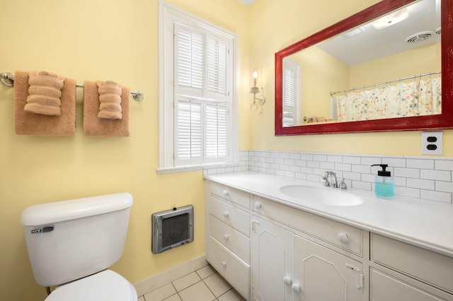 full bathroom with tile patterned floors, heating unit, visible vents, toilet, and vanity
