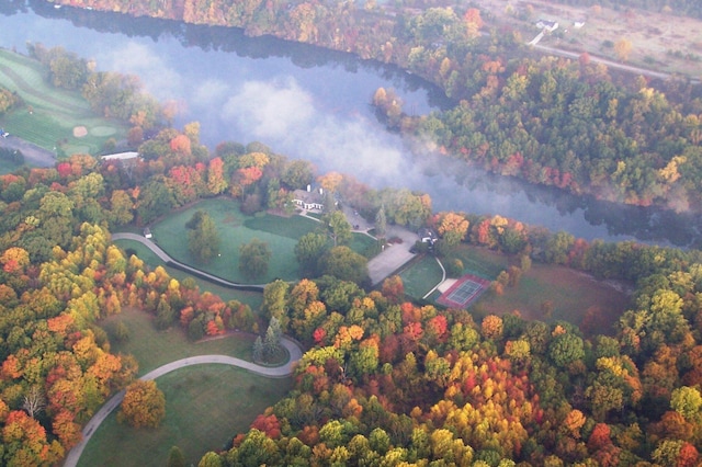 birds eye view of property featuring a view of trees
