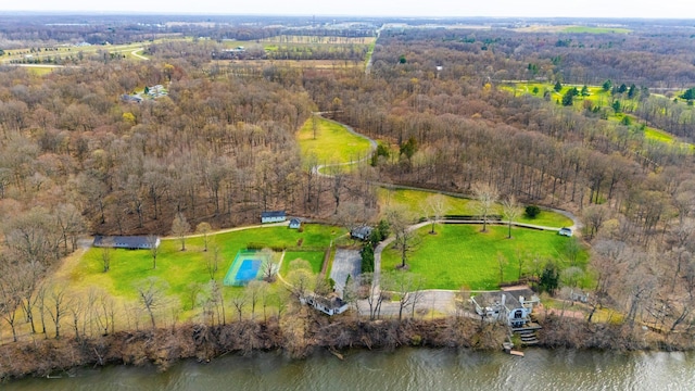 aerial view with a water view and a wooded view