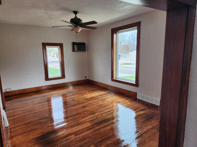 36707 Goddard Rd, Romulus, MI 48174 - spare room with visible vents, baseboards, wood finished floors, and a wealth of natural light