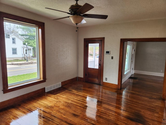 36707 Goddard Rd, Romulus, MI 48174 - interior space featuring visible vents, baseboards, ceiling fan, a textured ceiling, and hardwood / wood-style flooring