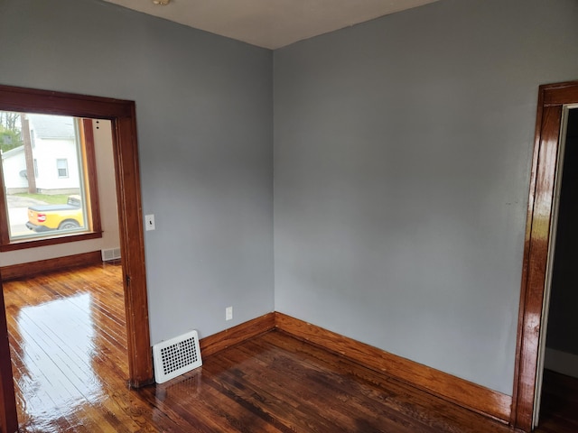 36707 Goddard Rd, Romulus, MI 48174 - unfurnished room with baseboards, visible vents, and hardwood / wood-style flooring