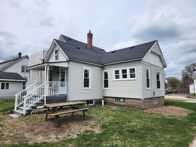 36707 Goddard Rd, Romulus, MI 48174 - rear view of house featuring a yard, a shingled roof, and a chimney