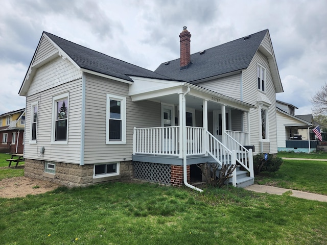 36707 Goddard Rd, Romulus, MI 48174 - back of property featuring a porch, a yard, a chimney, and roof with shingles