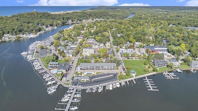 birds eye view of property featuring a forest view and a water view