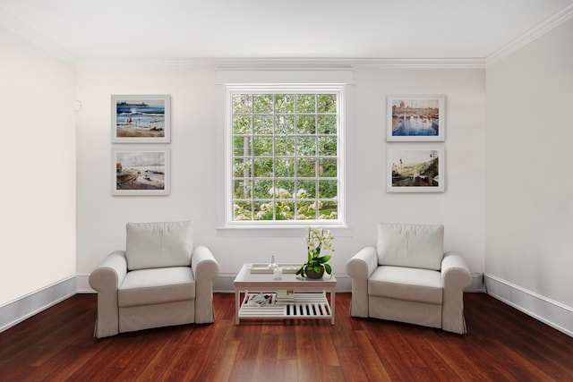 living area with baseboards, wood finished floors, and crown molding