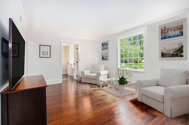 living area with baseboards, dark wood-style flooring, and crown molding
