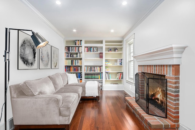 living area featuring dark wood-style floors, a fireplace, recessed lighting, and crown molding