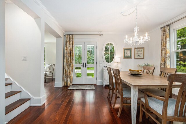 dining room featuring ornamental molding, baseboards, dark wood-style flooring, and an inviting chandelier