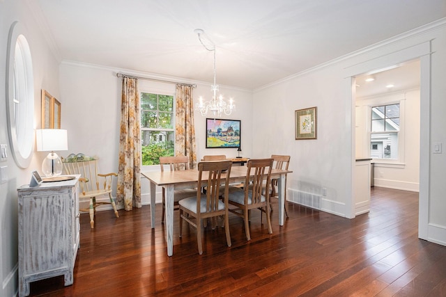 dining space with an inviting chandelier, ornamental molding, dark wood-style floors, and baseboards