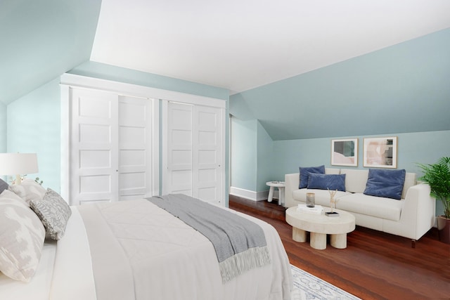 bedroom with lofted ceiling, baseboards, and wood finished floors