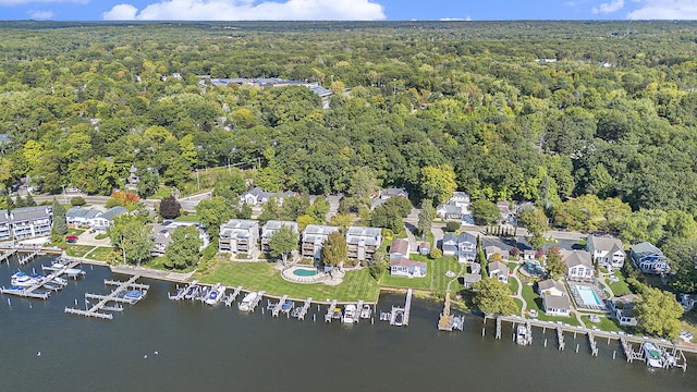 birds eye view of property featuring a wooded view and a water view