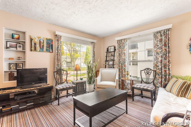 carpeted living area with a textured ceiling