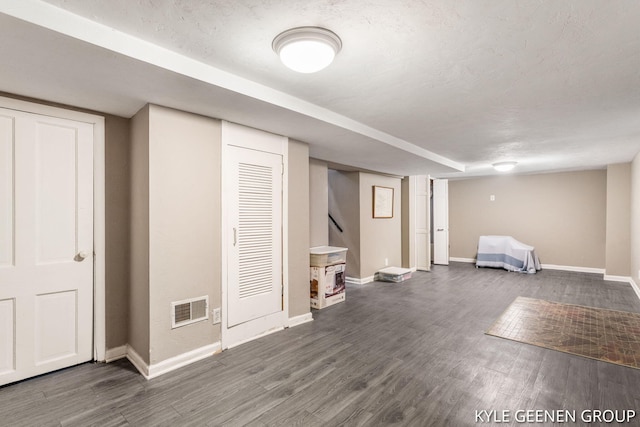 finished below grade area with baseboards and dark wood-style flooring