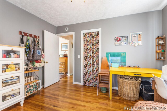 office space with wood finished floors and baseboards