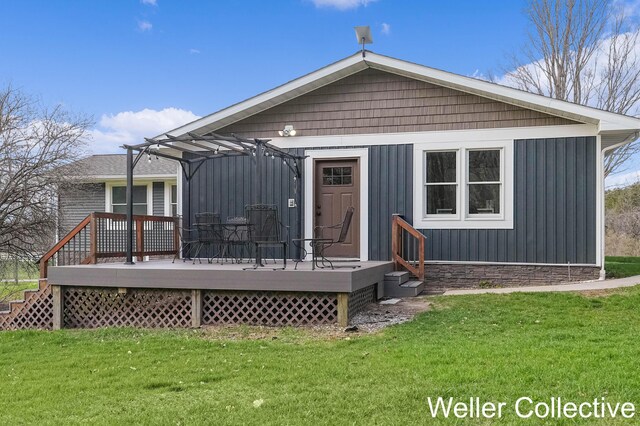 9090 E 32nd Rd, Cadillac, MI 49601 - back of property featuring a lawn and a deck